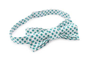 Photo of Stylish bow tie with green polka dot pattern on white background