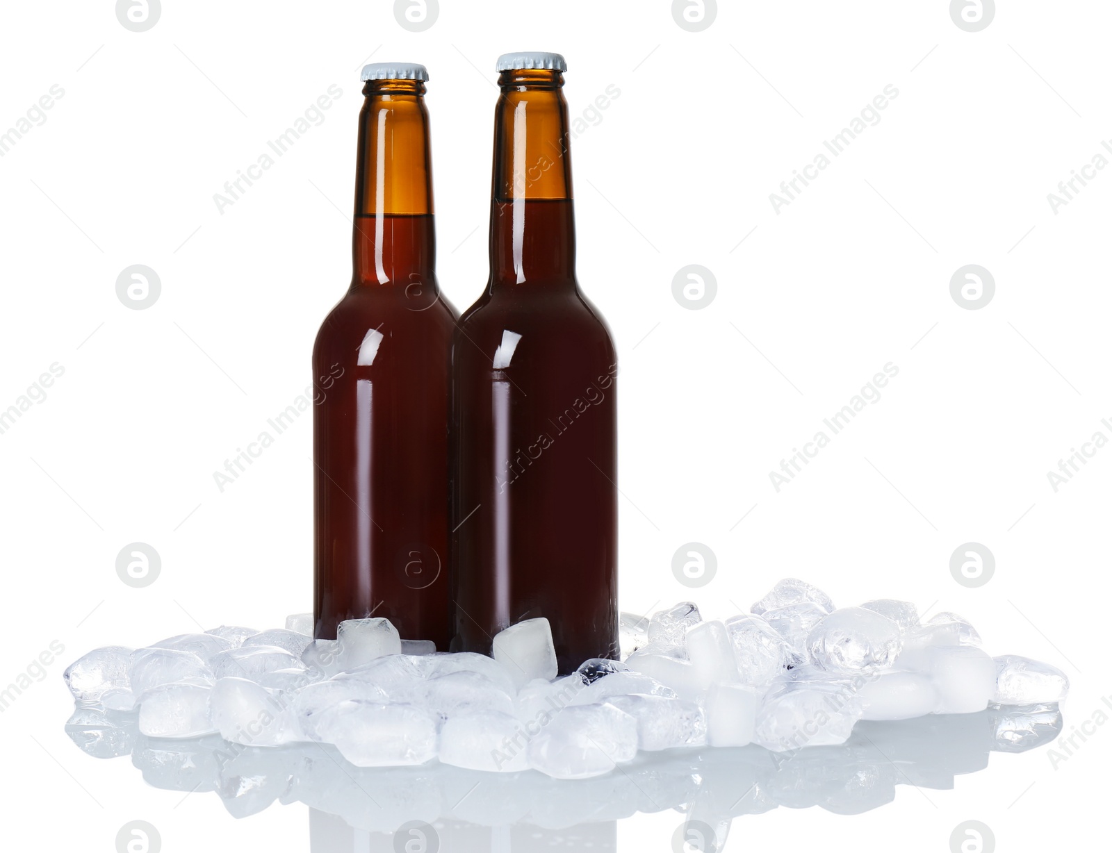 Photo of Bottles of beer and ice cubes on white background