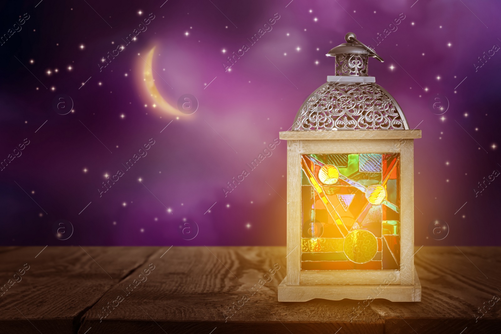 Image of Beautiful decorative Arabic lantern on wooden table at night, space for text. Fanous as Ramadan symbol