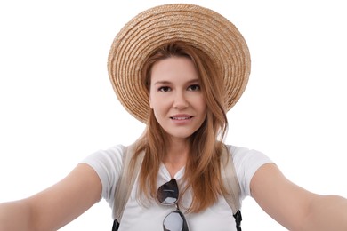 Beautiful woman in straw hat taking selfie on white background