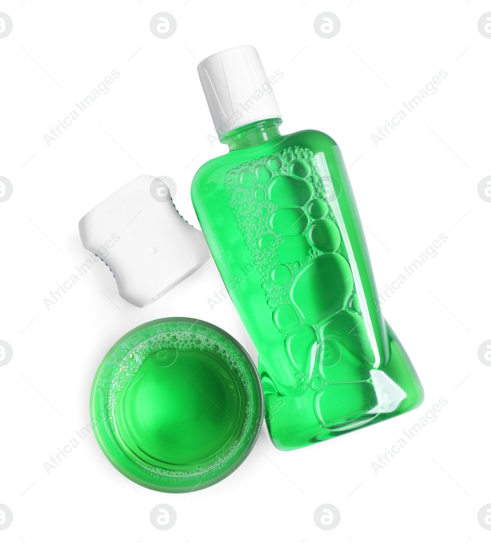 Photo of Fresh mouthwash, bottle, glass and dental floss isolated on white, top view