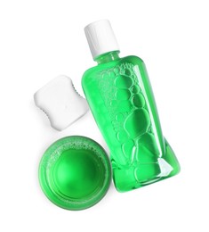 Fresh mouthwash, bottle, glass and dental floss isolated on white, top view