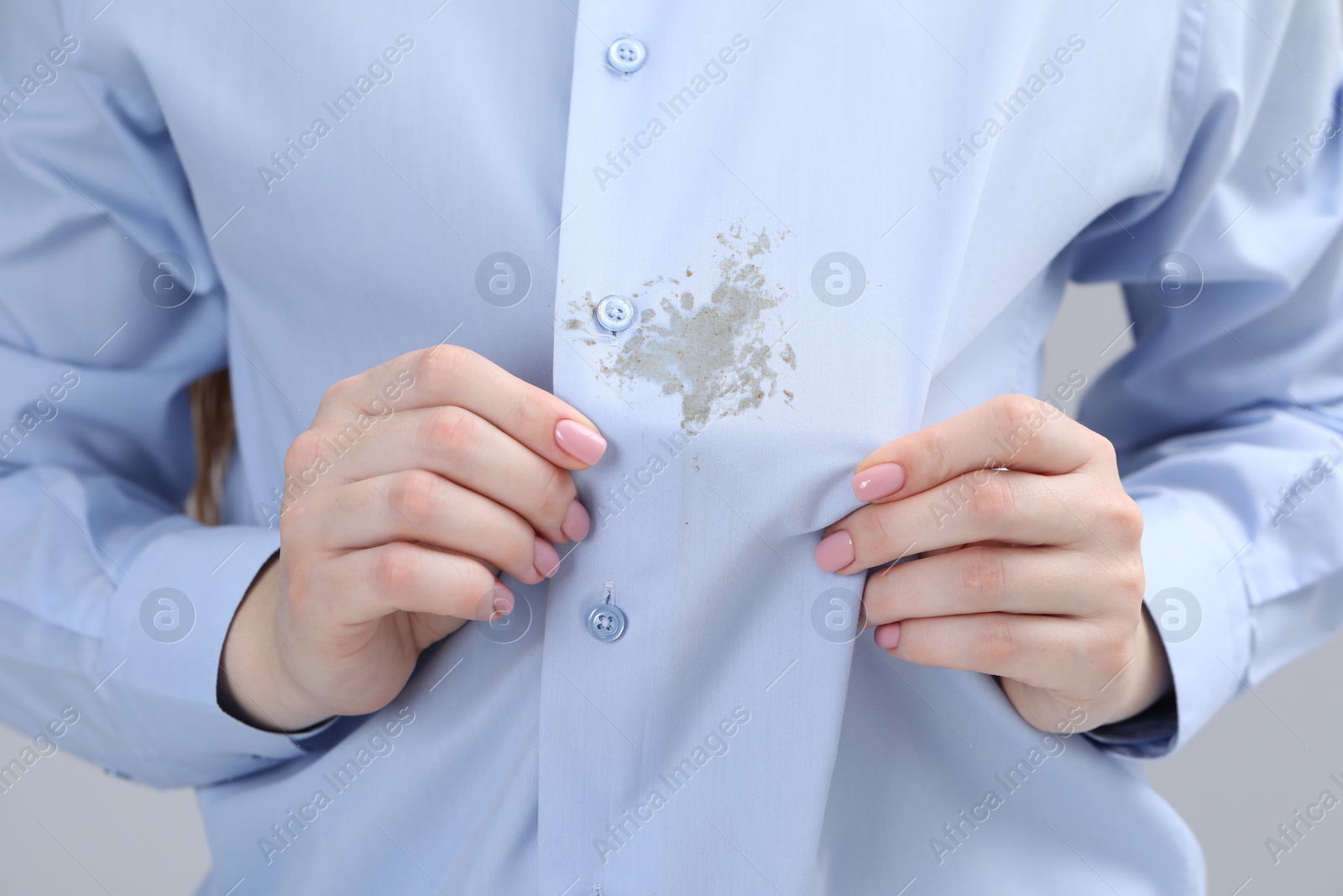 Photo of Woman showing stain on her shirt, closeup