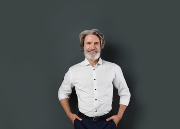 Portrait of handsome mature man on dark background