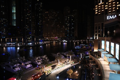 DUBAI, UNITED ARAB EMIRATES - NOVEMBER 03, 2018: Night cityscape of marina district with moored yachts