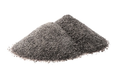 Piles of ground black salt isolated on white