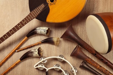 Set of different vintage musical instruments on wooden background, flat lay