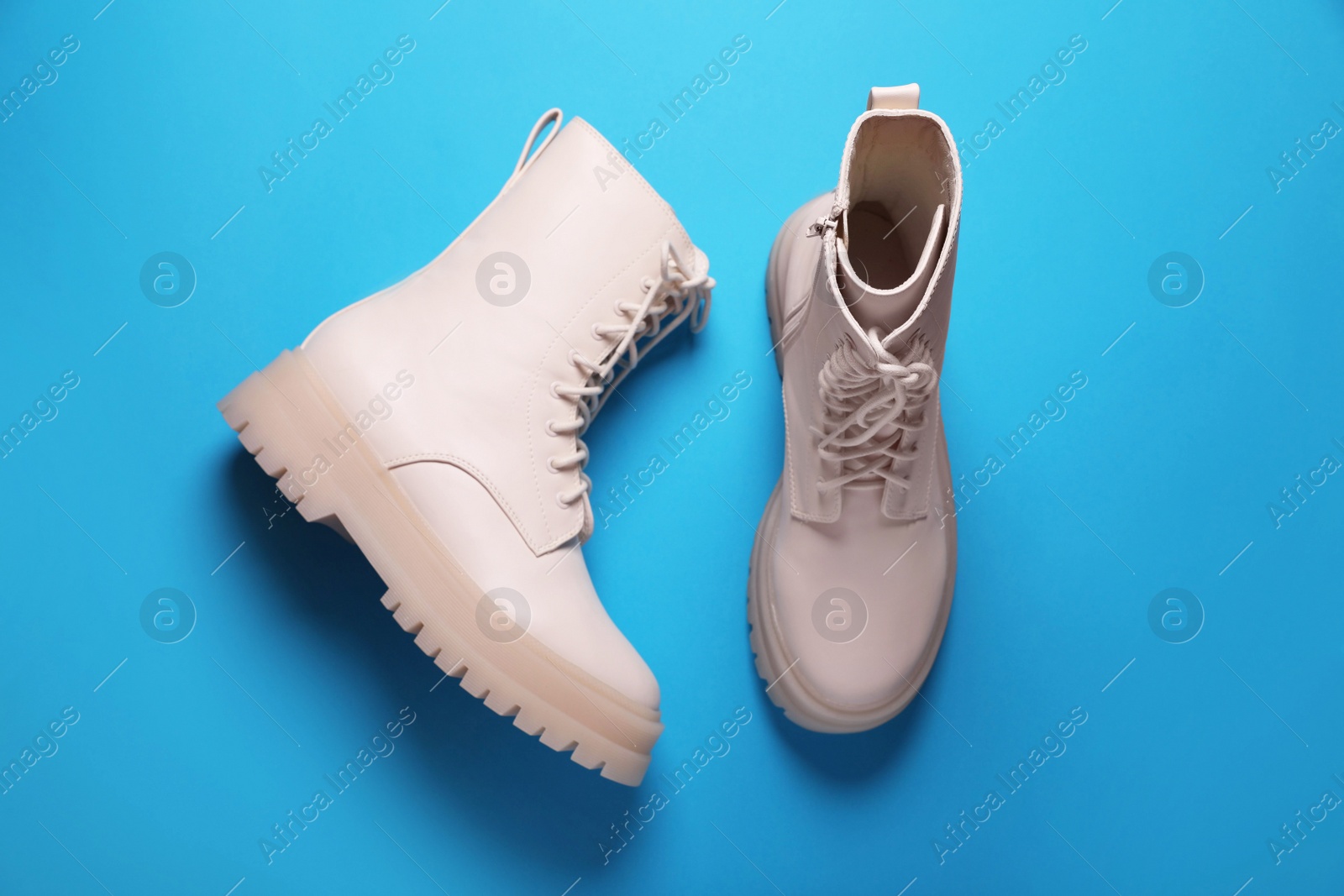 Photo of Pair of stylish leather shoes on light blue background, flat lay