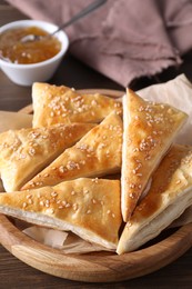 Photo of Delicious puff pastry on wooden table, closeup