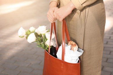 Woman with leather shopper bag outdoors, closeup