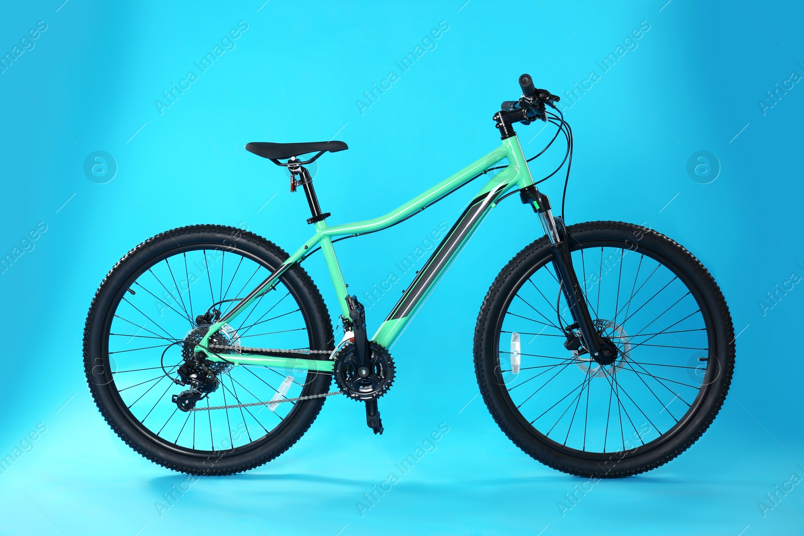 Photo of Modern bicycle on blue background. Healthy lifestyle