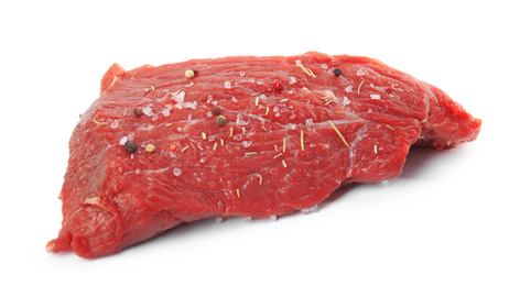 Photo of Fresh raw beef cut with spices isolated on white