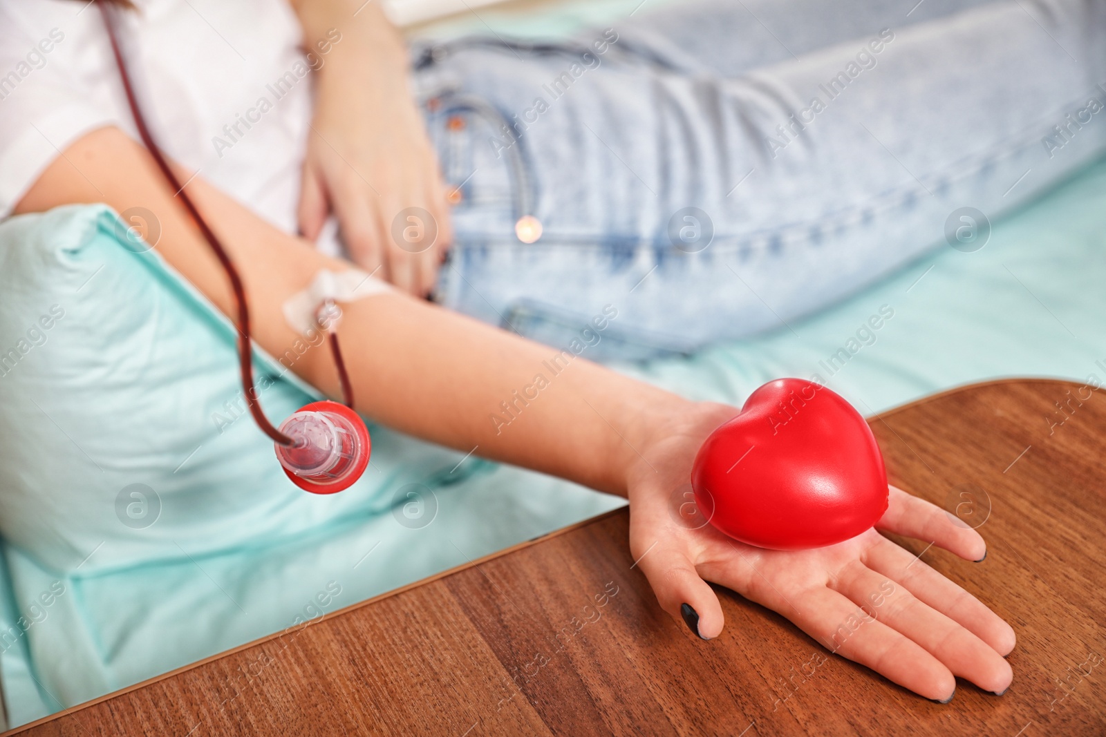 Photo of Teenager donating blood in hospital, closeup view