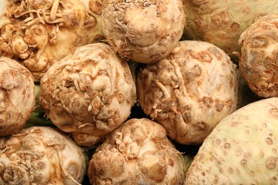 Photo of Fresh raw celery roots as background, closeup