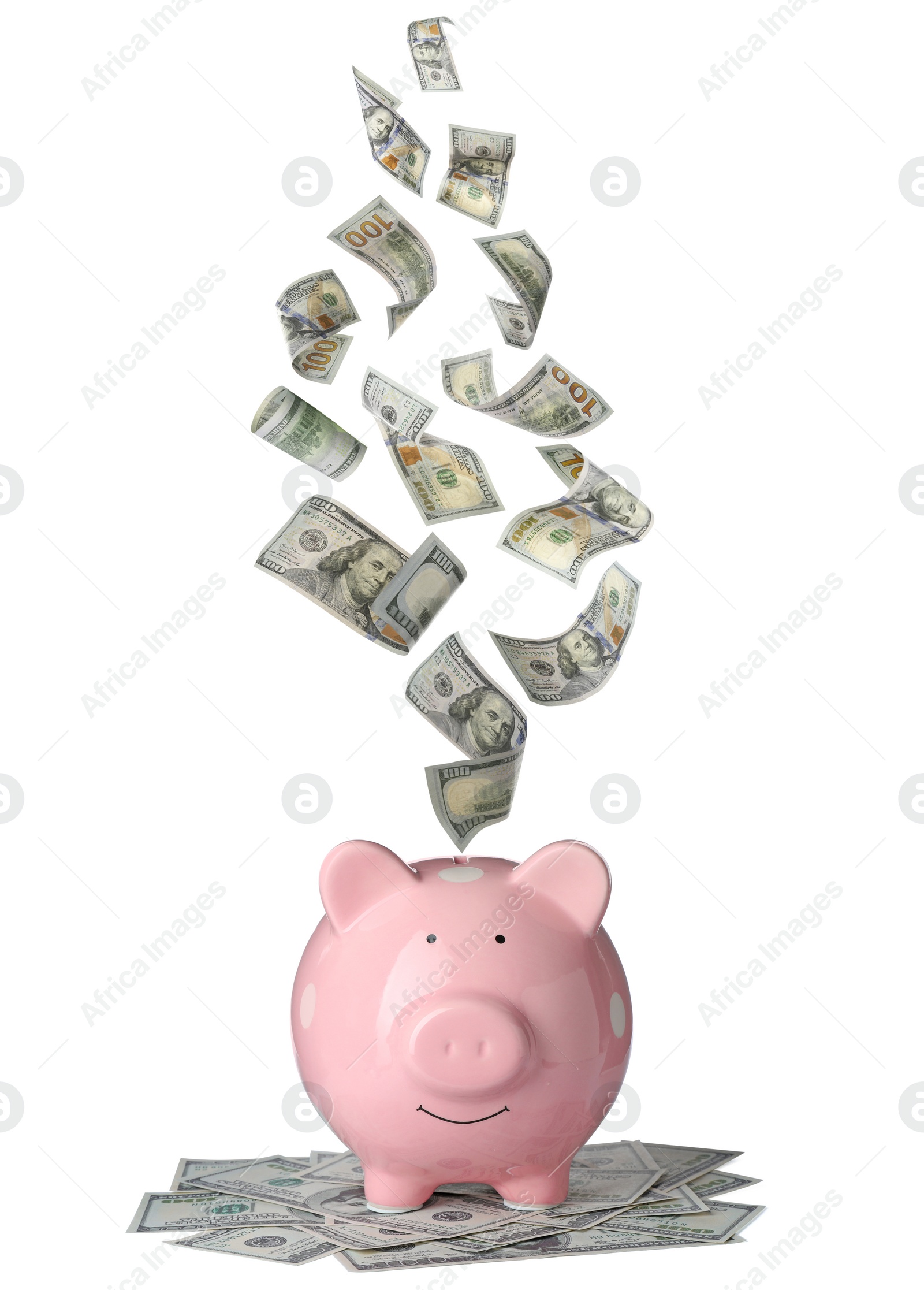 Image of Dollars falling into pink piggy bank on white background 