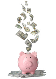 Image of Dollars falling into pink piggy bank on white background 