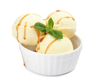 Photo of Delicious ice cream with mint and caramel sauce in dessert bowl on white background