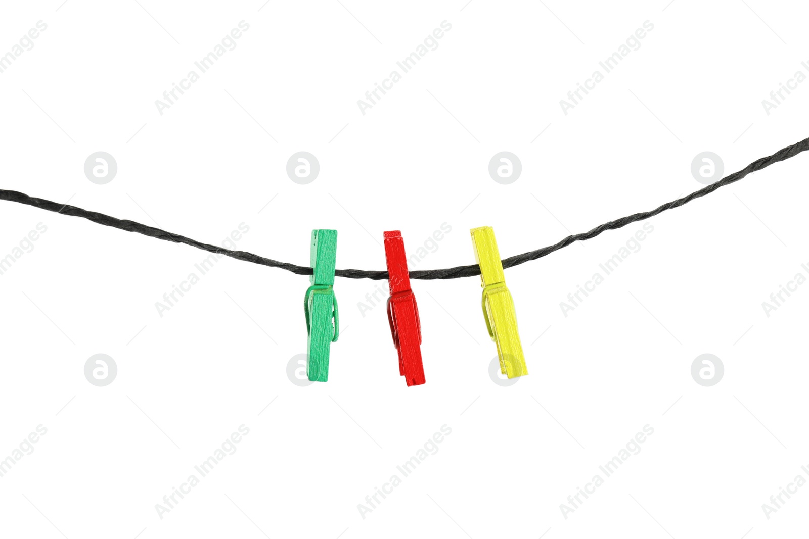 Photo of Colorful wooden clothespins on rope against white background