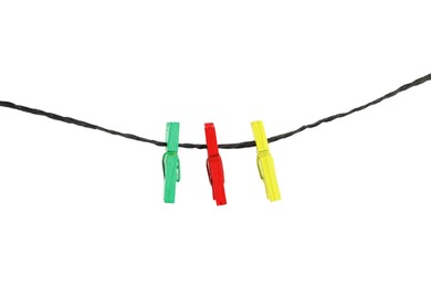 Colorful wooden clothespins on rope against white background