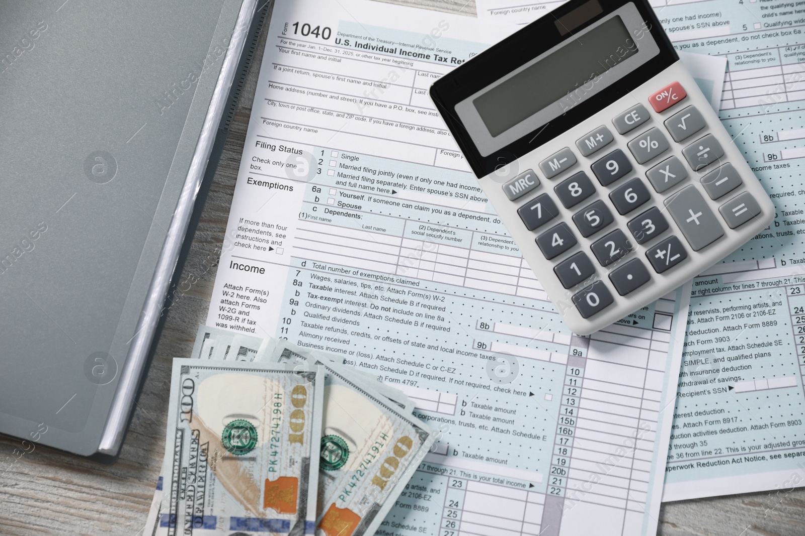 Photo of Payroll. Tax return forms, calculator and dollar banknotes on wooden table, flat lay