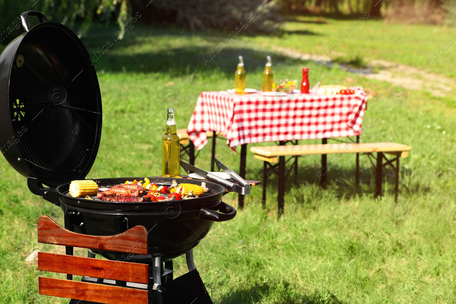 Photo of Modern barbecue grill with tasty food in park