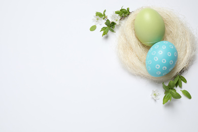 Flat lay composition with Easter eggs on white background. Space for text