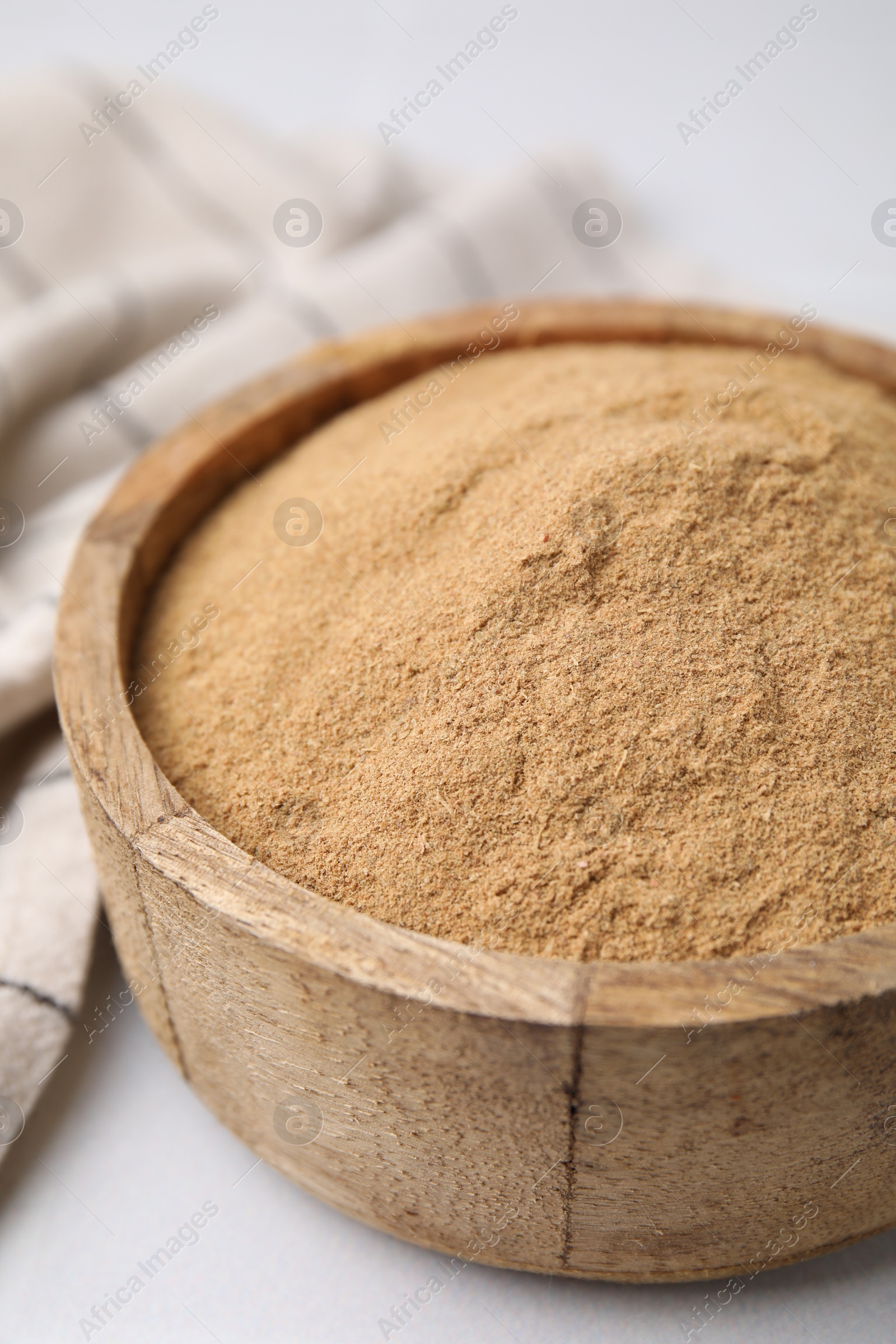 Photo of Dietary fiber. Psyllium husk powder in bowl on white table, closeup