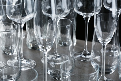 Set of empty glasses on grey table