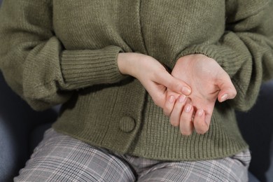 Woman suffering from trigger finger, closeup view