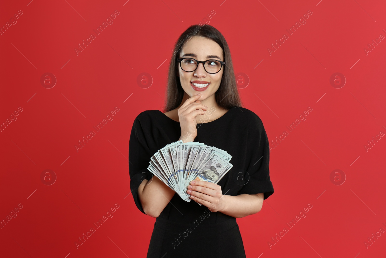 Photo of Young woman with money on crimson background