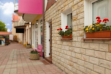 Blurred view of city street with modern stores