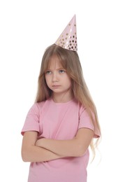 Photo of Unhappy little girl in party hat with crossed arms on white background