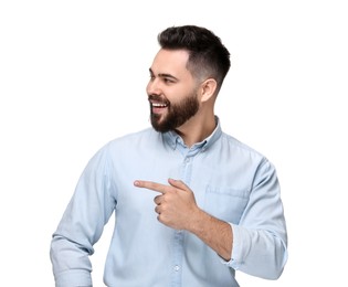 Happy young man with mustache pointing at something on white background