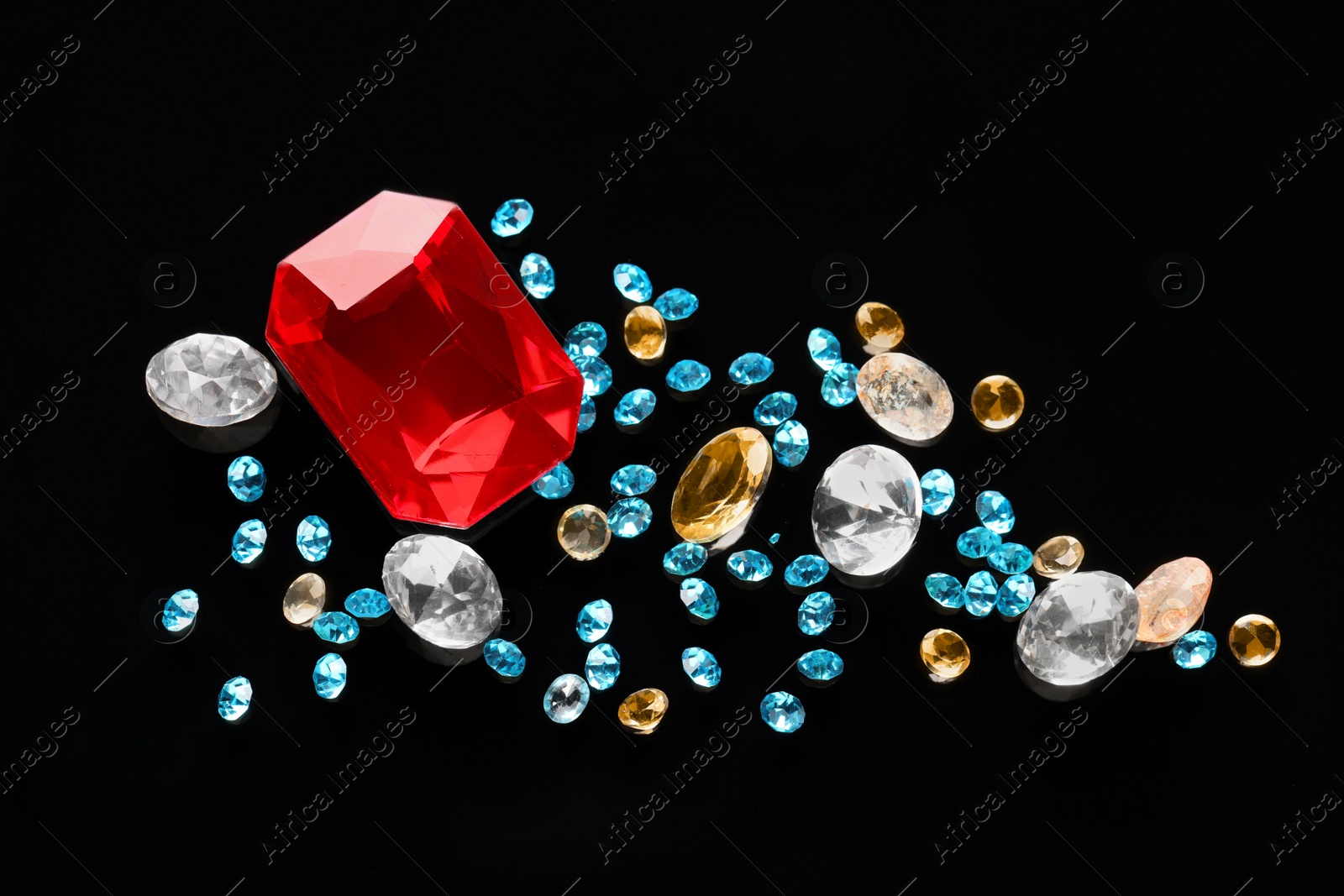 Photo of Different beautiful gemstones for jewelry on black background, flat lay