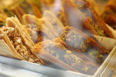 Photo of Closeup view of turkish pastries in shop through window glass