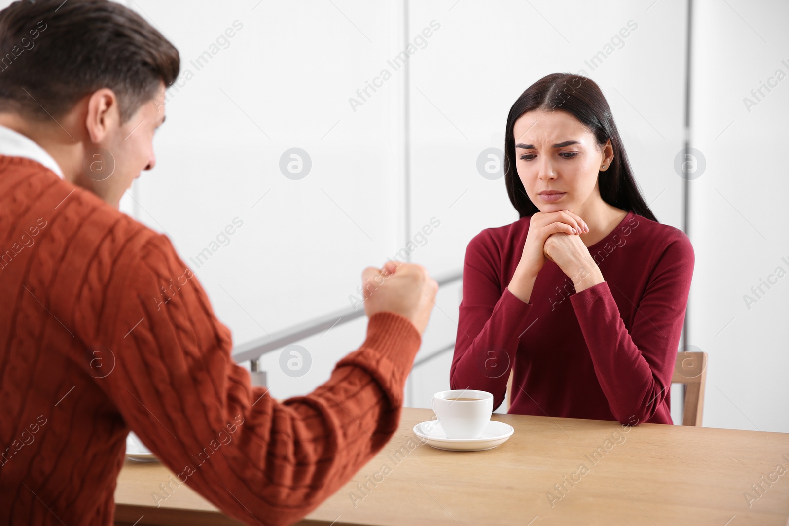 Photo of Couple having quarrel in cafe. Relationship problems