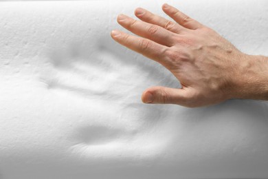 Photo of Man with orthopedic memory foam pillow, above view