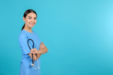 Photo of Portrait of medical assistant with stethoscope on color background. Space for text