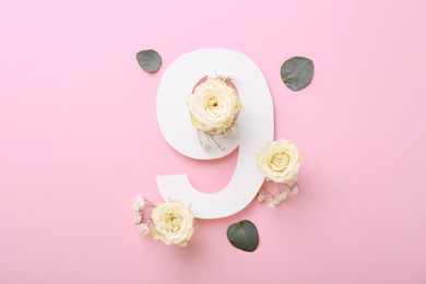 Photo of Paper number 9, eucalyptus leaves and beautiful flowers on pink background, flat lay