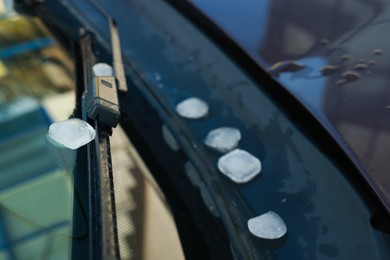 Photo of Closeup view of car window with hail grains after thunderstorm