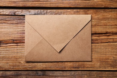 Photo of Letter envelope on wooden table, top view