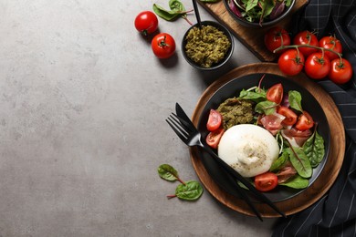 Photo of Delicious burrata salad served on light grey table, flat lay. Space for text