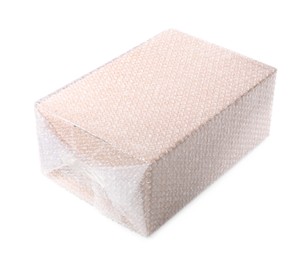 Photo of Cardboard box packed in bubble wrap isolated on white