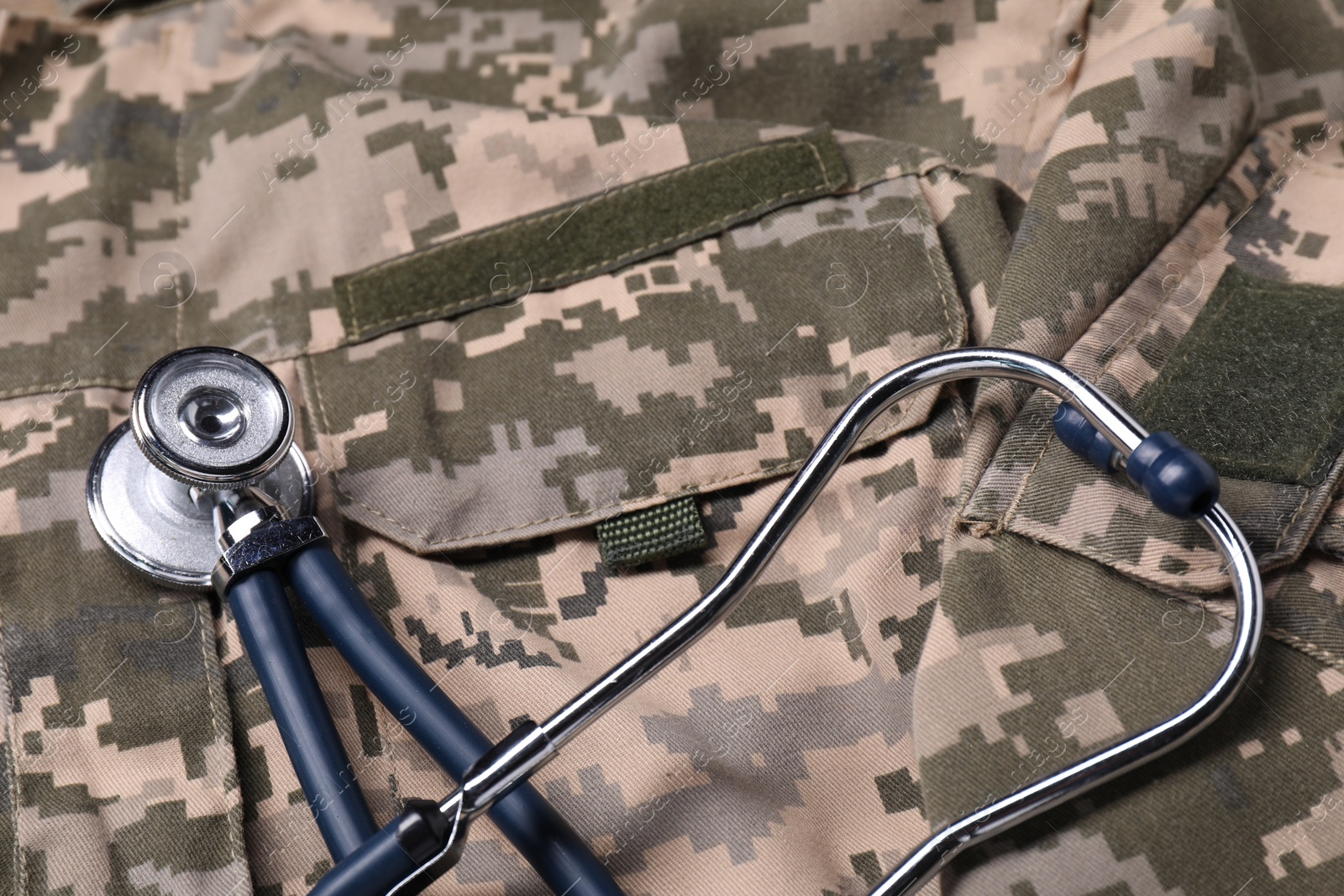 Photo of Stethoscope on soldier uniform, closeup. Military service