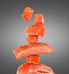 Image of Cut fresh salmon falling on grey gradient background