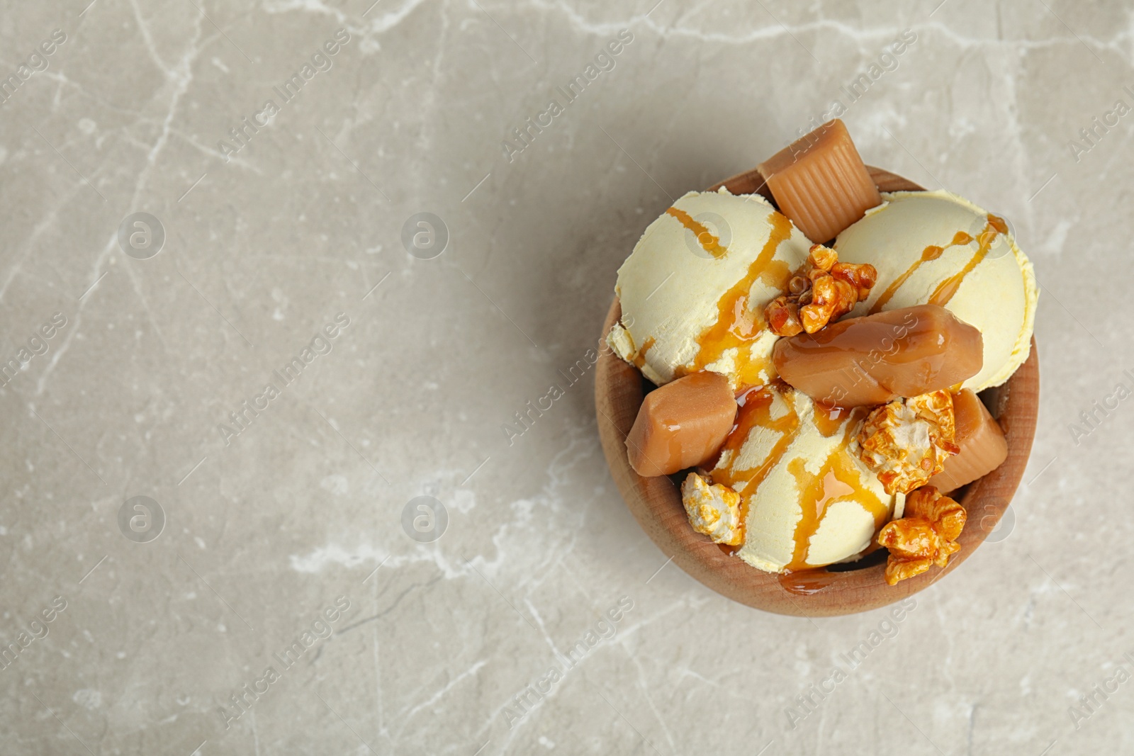 Photo of Flat lay composition with delicious ice cream in dessert bowl on table, space for text