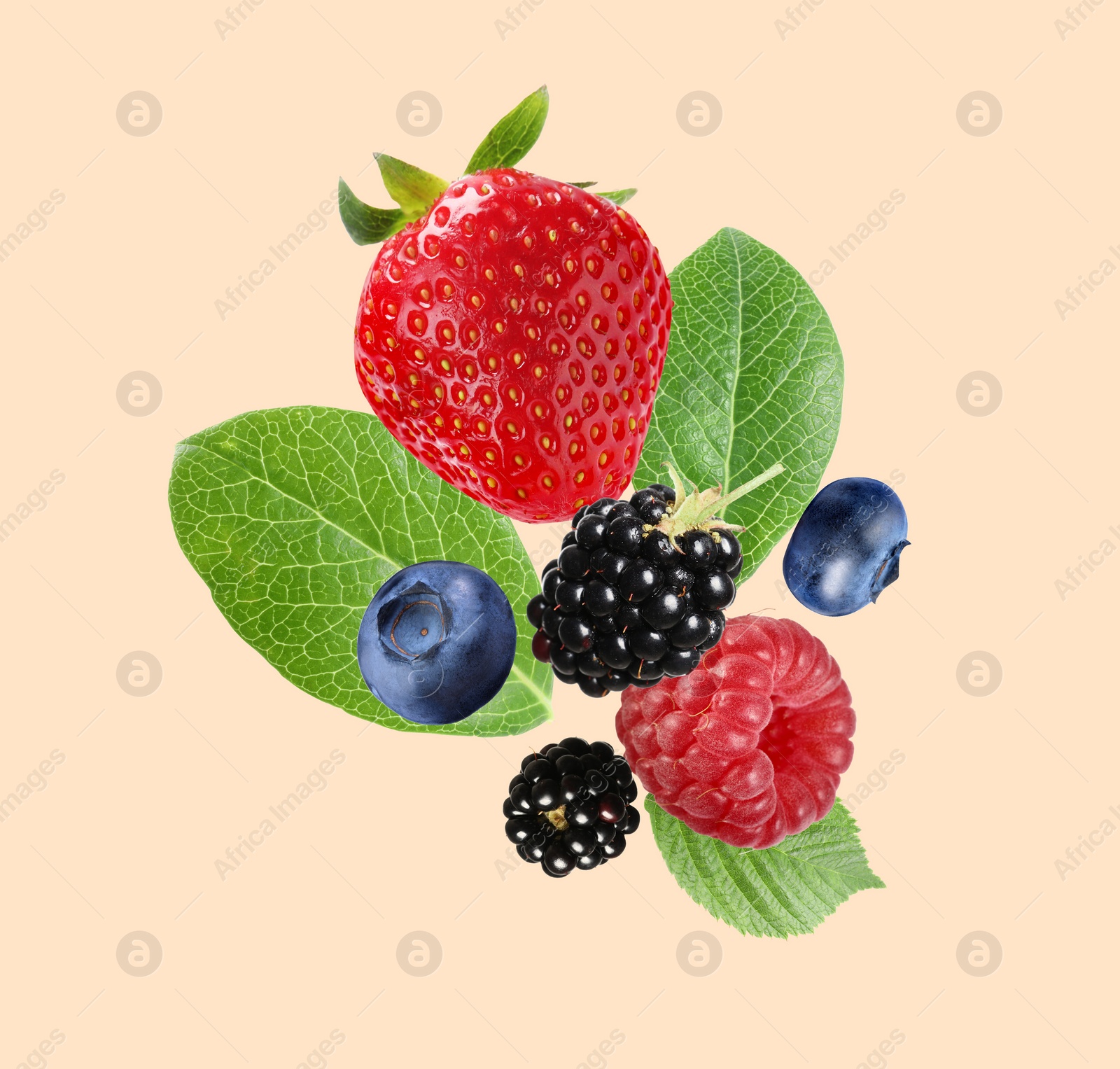 Image of Many different fresh berries falling on beige background