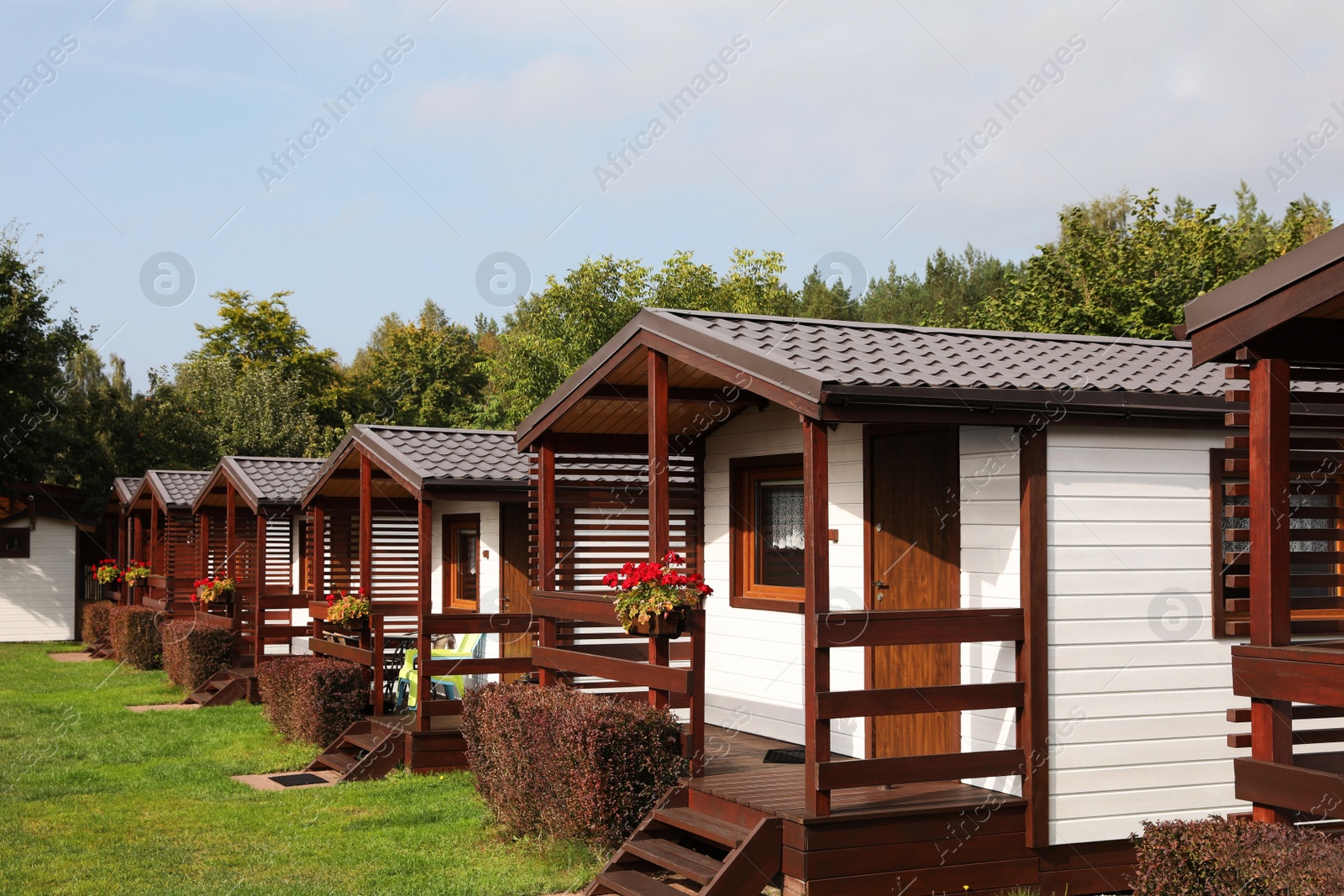 Photo of Beautiful wooden beach houses and green trees outdoors