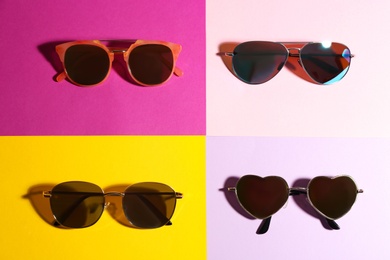 Stylish sunglasses on color background, flat lay. Summer time