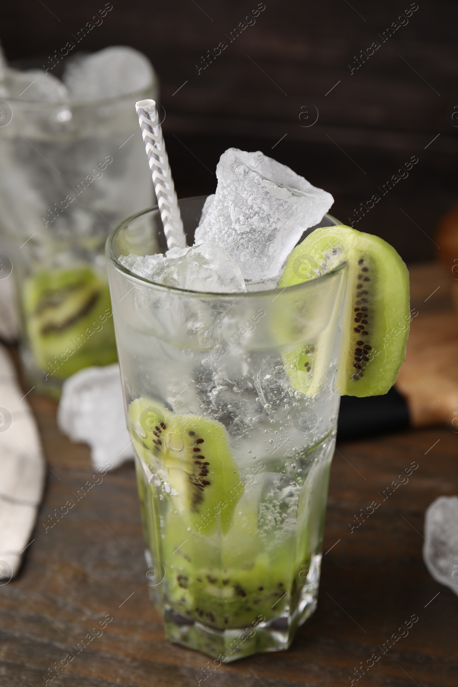 Photo of Glass of refreshing drink with kiwi on table, closeup